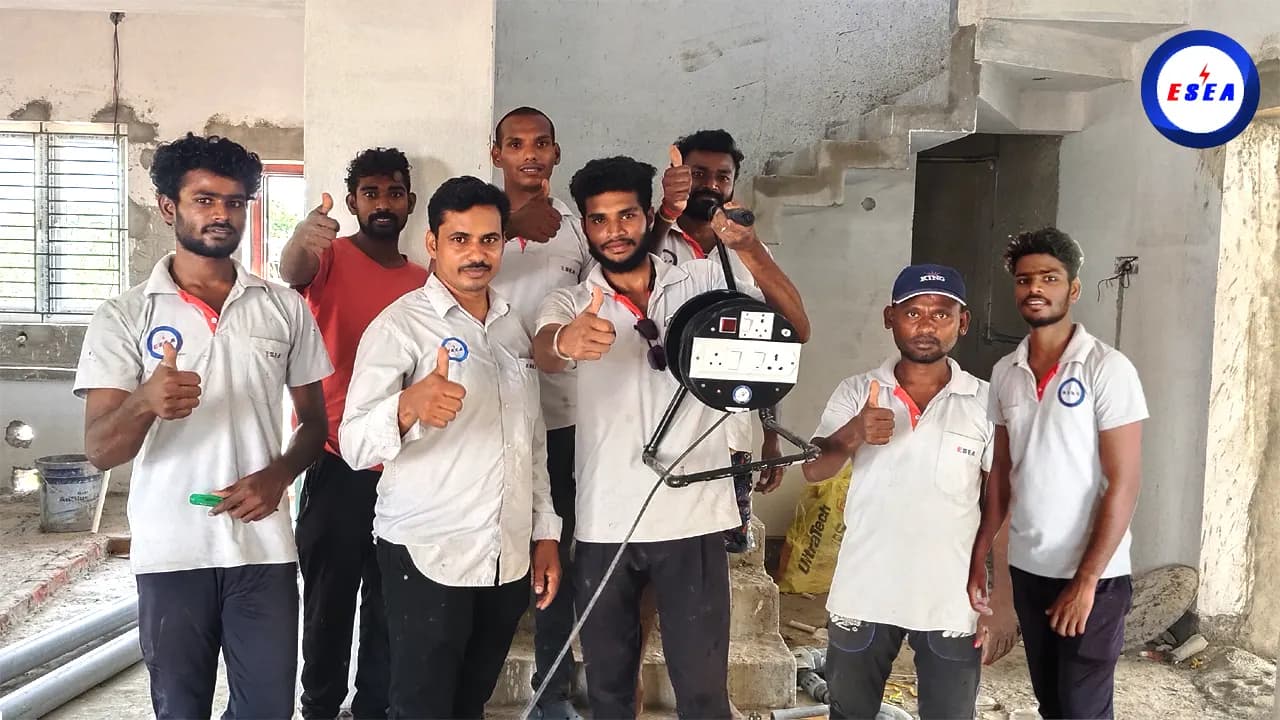 ESEA electrical and plumbing technicians in uniform at a house under construction