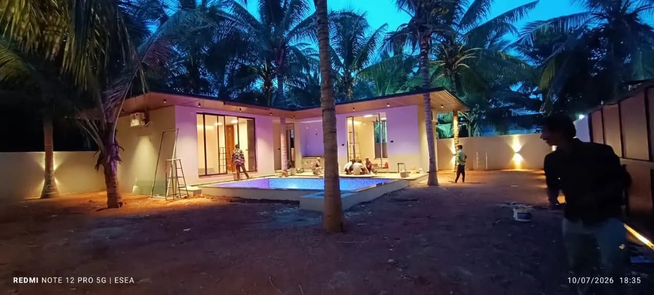 Villa with swimming pool lit up at dusk after ESEA lighting work